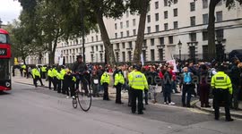 Penny farting cycling down Whitehall at covid protest