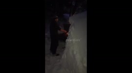 Man uses barbecue between huge snow drifts