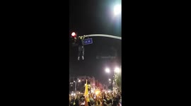 Laker Fans Create Human Trampoline To Catch Fellow Fan Hanging On To Traffic Light