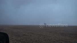 Watch as mini tornadic 'gustnado' races across Ohio landscape on a stormy day pulling up crops and throwing debris through the air