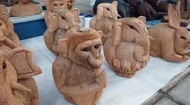 Roadside artist carves figurines out of coconut in southern India