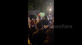 Crowd-control car in Thailand is pushed around by protesters