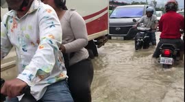 Motorists battle through flooded roads in Cambodia
