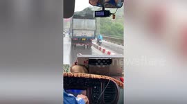 Kind truck driver shields motorcycle rider from storms in Vietnam