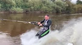 Guy Performing Barefoot Water Skiing Stunts On River Ouse in England