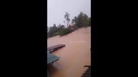 Vietnamese rescuers save residents trapped on roof of flooded house
