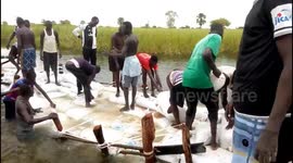 Youths work to stop flooding after the Nile overflows in South Sudan
