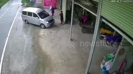 Reckless minibus narrowly misses women after crashing into curb in China