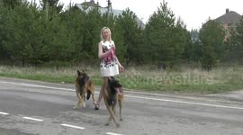 Girl and two malinois dancing in the street