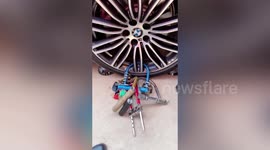 Chinese villagers attach locks to wedding car wheel while asking for money