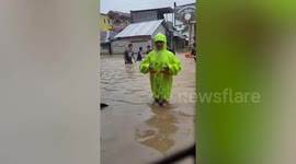Kids play basketball on flooded court after tropical storm Saudel brings heavy rain to the Philippines