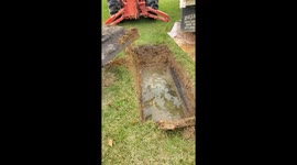 Spooky scary skeletons! West Virginia gravedigger opens waterlogged vault in terrifying video ahead of Halloween