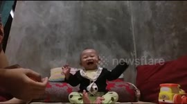 Laughing babies playing with his mothers so hard