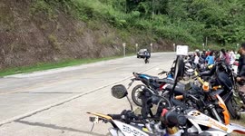 Motorcycle food carts speed round corner on mountain road