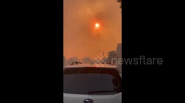 Dark orange skies as Silverado Fire slowly approaches the city of Irving, California