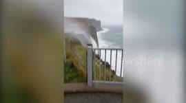 This dramatic footage shows a waterfall being blown backwards by high winds
