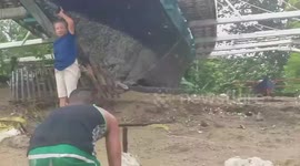 Storm-hit residents salvage wood from beach amid Typhoon Molave devastation