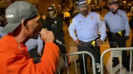 Activist Confronts Line Of Police In Philadelphia Riots (Contains strong language)