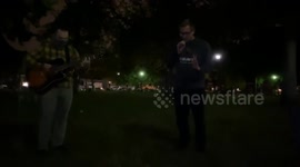 Musicians Play Guitar And Sing As Riots Erupt In Philadelphia