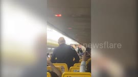 Shocking video footage shows a massive fight breaking out between passengers onboard a Ryanair flight leaving staff helpless in the chaos
