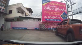 A large earth mover captured on car dash cam, being unloaded from a tow truck, in preparation for Loy Krathong festival.