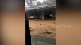 Amazing moment man being washed away by Typhoon Molave floods is saved by neighbours