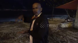 The reaction of the old man who was being interviewed, but suddenly high waves came from behind and almost hit him