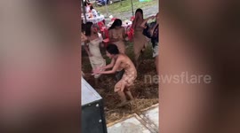 Thai bride dances through muddy field with bridesmaids after heavy rain hits wedding