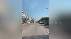 Truck drives along highway with doors flung wide open in Thailand