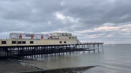 Thousands of starlings burst out from under The Royal Pier In Aberystwyth, West Wales, UK