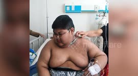 Indonesian boy, 13, carried to hospital after getting so fat he was bed-ridden