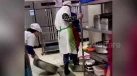 University canteen worker washes vegetables with FEET in central China