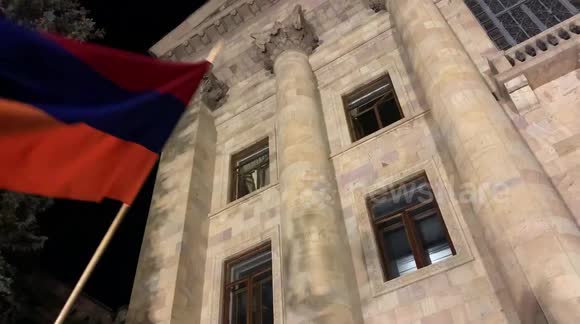 Nagorno-Karabakh peace deal protester flies armenia flag outside parliament