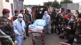 Paramedics move the body of key Palestinian negotiator who died of Covid-19