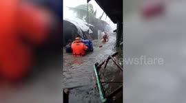 Typhoon Vamco: Rescuers walk through waist-high water to evacuate residents in the Philippines