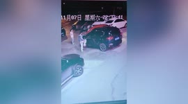 Furious Chinese woman kicks and scratches car 'blocking her way'