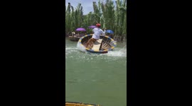 Dance of Shaking the basket boat under water is very skilled by a Vietnamese man