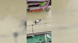 Residents drink coffee on makeshift raft during Typhoon Vamco floods in the Philippines