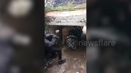 Motorcycle riders have to duck under ridiculously low 4ft tall underpass in Indonesia