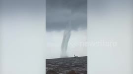 Terrifying waterspout moves across sea towards boat in Indonesia