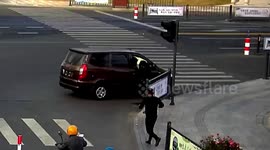 Policeman leaps into driverless van through window to stop it rolling backwards in China