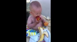 Funny baby eate fruits