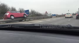 Car balanced on top of central reservation on M275, UK