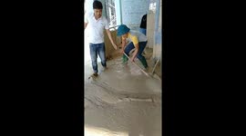 Residents clean thick mud from house after flash floods hit central Vietnam