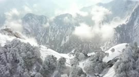 Stunning drone footage showcases snow-covered mountaintop in north China