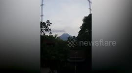 Thick white smoke spews from Mount Merapi volcano in Indonesia