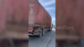 Truck carries dangerous rusty scrap-metal cargo tied with only a rope
