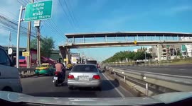 Reckless motorcycle rider launches into the air after hitting concrete road barrier