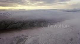Dramatic Cloud Inversion Over Mountain Snow - Drone Clip 10