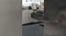 Beaten-up old Lada drives with a LORRY CABIN strapped to roof